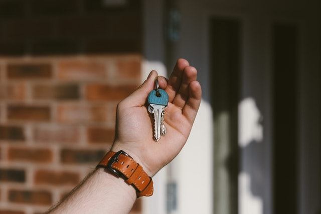A Man's Hand Holding Keys to His New Home